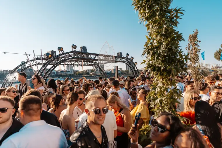 Tanzende Crowd vor dem Bühnenbogen in der Nachmittagssonne beim Golden Flame Mid Summer am Rhein in Köln