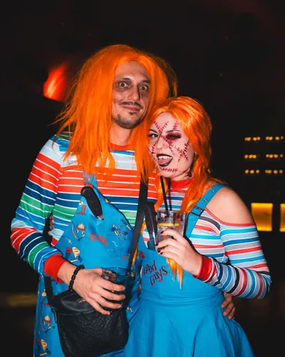 Two guests in matching Chucky doll costumes with orange wigs and striped tops at Spooky Flame 2025 in Cologne