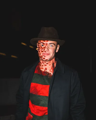 Guest as Freddy Krueger with hat, striped jumper and make-up at Spooky Flame 2025 in Cologne