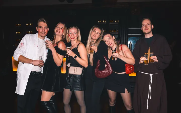 Group in a lab coat, a monk’s robe and black outfits at Spooky Flame 2025 in Cologne